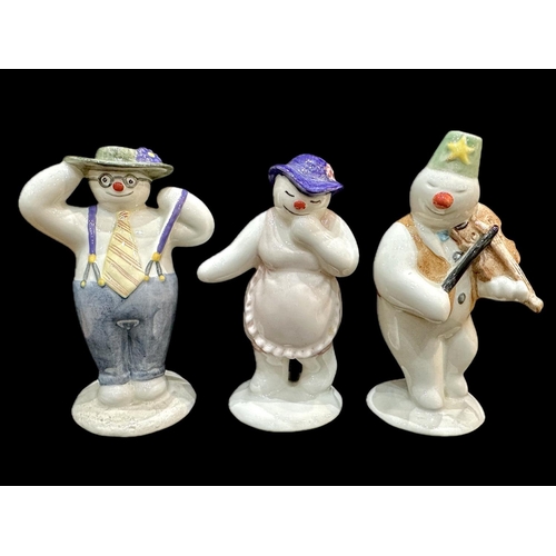 642 - Three Royal Doulton Snowman Figures, comprising Lady Snowman, Violinist Snowman and Stylish Snowman.