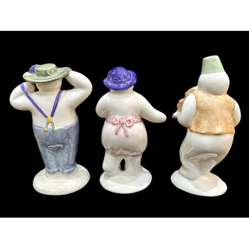 642 - Three Royal Doulton Snowman Figures, comprising Lady Snowman, Violinist Snowman and Stylish Snowman.