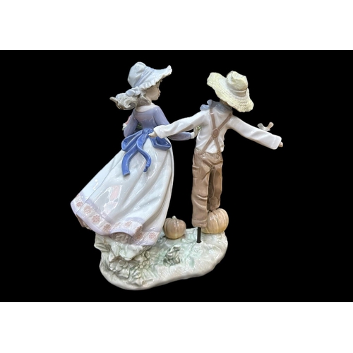 647 - Lladro Figure No. 5385, 'Lladro Figurine 5385 ''Scarecrow'' 9'' tall, depicting a lady with a scarec... 