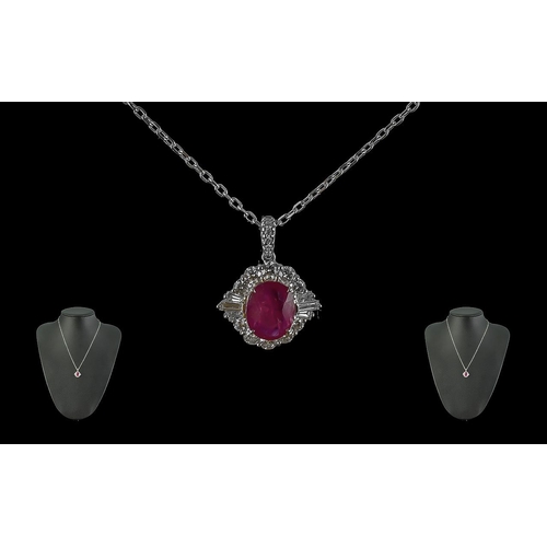 131A - 18ct White Gold Oval Ruby and Diamond Cluster Pendant on an 18ct white gold chain, boxed. Ruby 2.35c... 