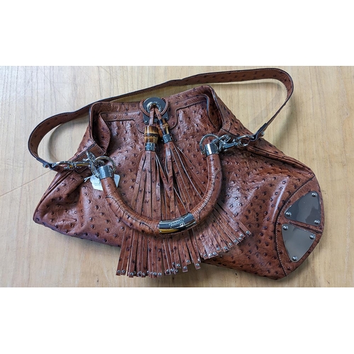 1451 - Genuine Gucci Ostrich Handbag, tan with hand and shoulder straps, two front decorative tassels, chro... 