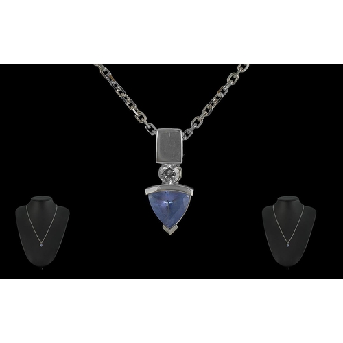 53A - 14ct White Gold Tanzanite Pendant, suspended on a chain marked 585 Italy.  Drop pendant in arrow sha... 