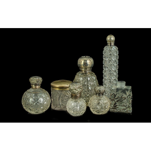 766 - Collection of Perfume Bottles, silver topped, seven in total, various shapes and designs.