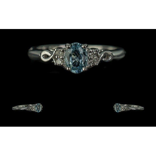 133A - 18ct White Gold Ladies Contemporary Dress Ring, central pale blue stone with diamond set shoulders. ... 