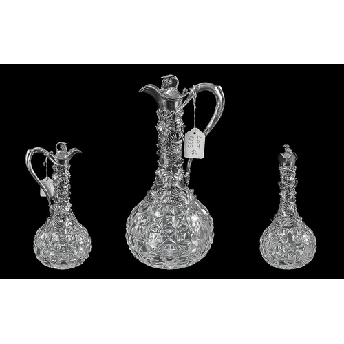 1233 - Four Pieces of Silver Plated Ware including a cruet set and stand,  two silver plated claret jugs, a... 