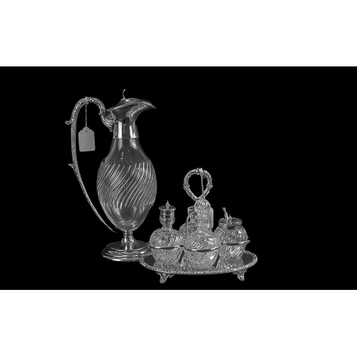 1233 - Four Pieces of Silver Plated Ware including a cruet set and stand,  two silver plated claret jugs, a... 