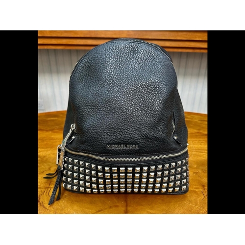 1521 - Michael Kors Interest. Ladies Michael Kors Black Leather Silver Studded Back Pack. Comes with its Or... 