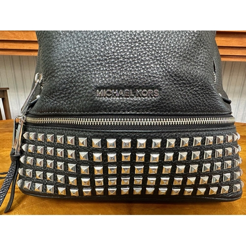 1521 - Michael Kors Interest. Ladies Michael Kors Black Leather Silver Studded Back Pack. Comes with its Or... 