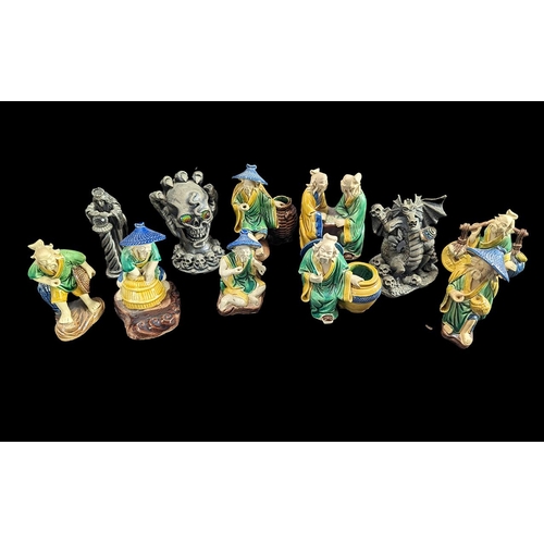 1533 - Collection of Eight Small Japanese Figurines, depicting figures playing checkers, carrying water pot... 