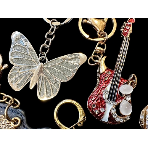 417A - A Collection of Assorted Novelty Key Rings. Designs include handbags, a guitar, butterfly, a cross e... 