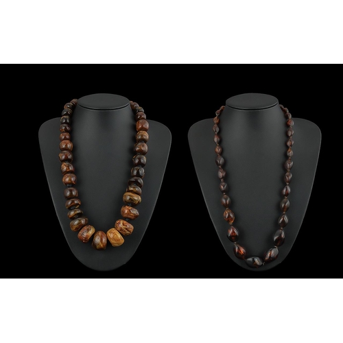 464 - Two Amber Coloured Bead Necklaces, one 22'' length with larger beads, one 24'' smaller beads.