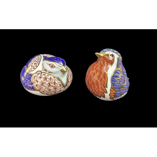 555 - Two Royal Crown Derby Bird Paperweights, comprising a Robin and one other, both with gold stoppers.