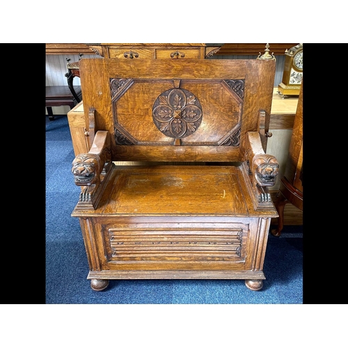 1036 - Early 20th Century Oak Monk's Bench with fold over back rest, lion carved arm rests, hinged seat and... 