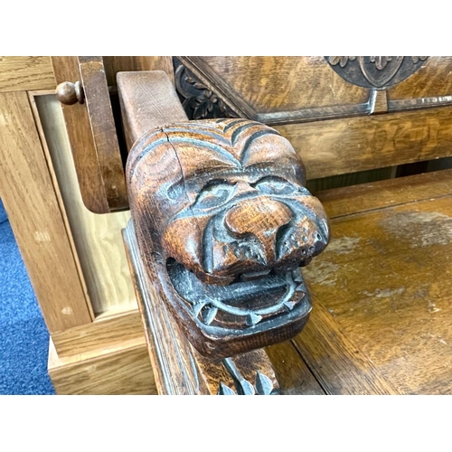 1036 - Early 20th Century Oak Monk's Bench with fold over back rest, lion carved arm rests, hinged seat and... 