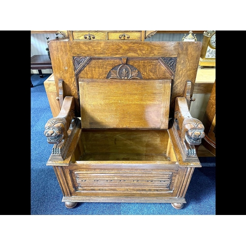 1036 - Early 20th Century Oak Monk's Bench with fold over back rest, lion carved arm rests, hinged seat and... 