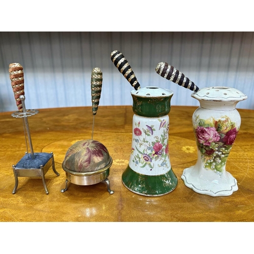 1435 - Four Vintage Hat Pin Holders, comprising two china floral decorated holders, an EPNS stand with thre... 