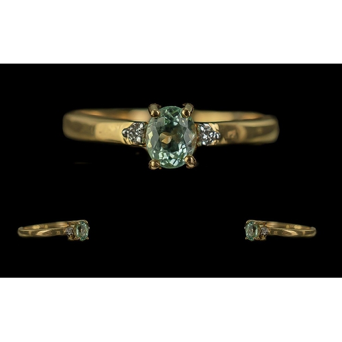 258 - 18ct Gold Ladies Dress Ring, central pale green stone with a single diamond on each shoulder.  Ring ... 