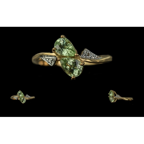 259 - 18ct Gold Ladies Dress Ring, two central pale green pear shaped stones with diamond shoulders.  Ring... 