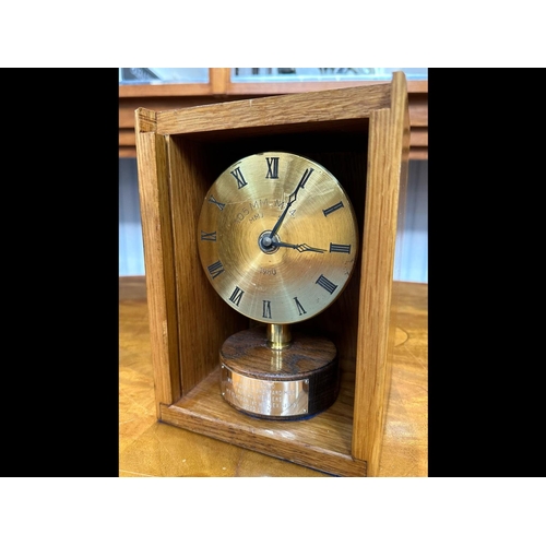 1352 - Military Interest A Presentation Clock housed in a wooden box. Together with a trophy of two armed s... 