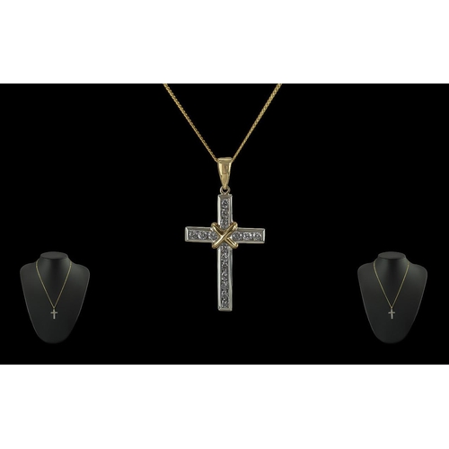 132B - 18ct Gold Two Tone Cross Set with Diamonds, full hallmark and diamond weight of 0.50pts marked to to... 