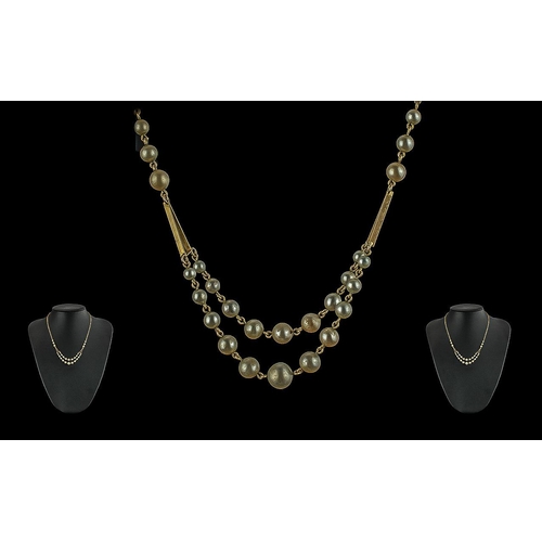 61A - Ladies Vintage and Pleasing 9ct Gold and Pearl Set Necklace of stylish design, marked 9ct, the pearl... 