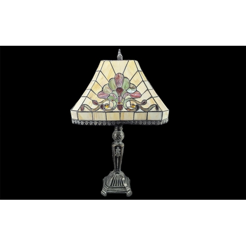 1062 - Large Tiffany Style Table Lamp, with pink cream and green decoration, raised on a heavy decorative m... 