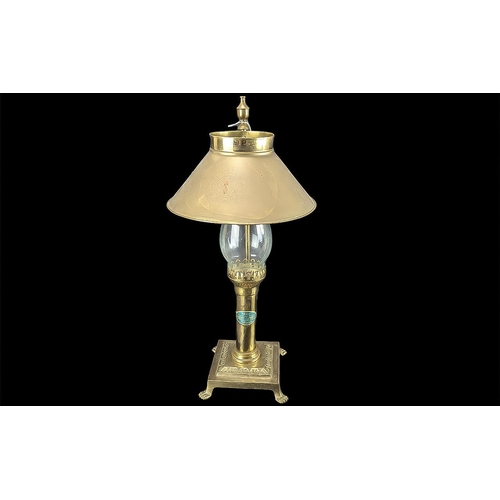 1250 - Brass Candle Lamp, 20'' high, raised on a square base with claw feet.