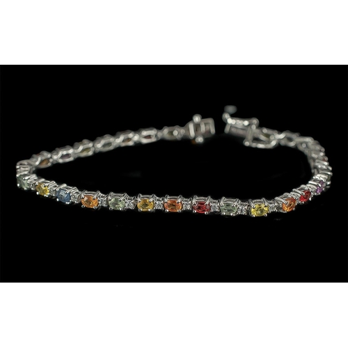 196 - Multi Sapphire Tennis Bracelet, a row of sapphires in the fancy colours of pink, green, yellow, oran... 