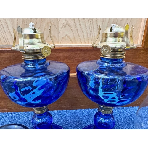 783 - Collection of Oil Lamps, including blue glass, flint glass, amber glass, spare chimneys, etc.  Toget... 