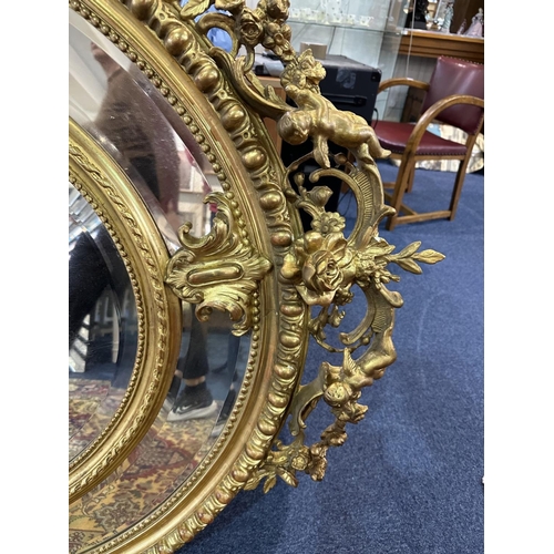 1031 - Impressive Rococo Style Oversized Mirror, Decorated In Gilt Design, Cherub Decoration Throughout. Ce... 