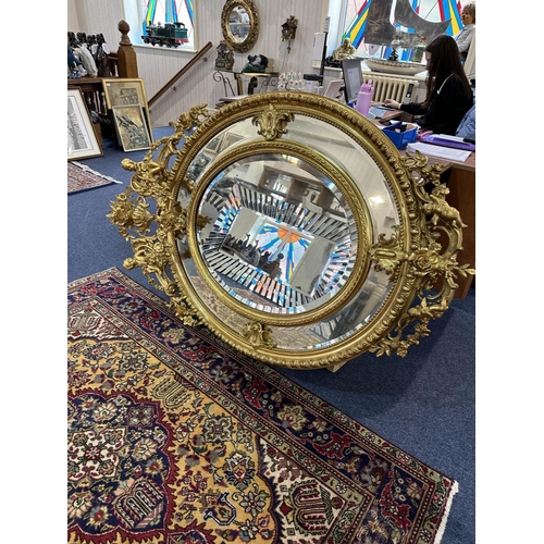 1031 - Impressive Rococo Style Oversized Mirror, Decorated In Gilt Design, Cherub Decoration Throughout. Ce... 