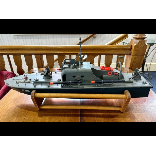 1440 - Model Torpedo Boat, Radio Controlled, with control unit and spare parts, and stand.  Measures 37'' l... 