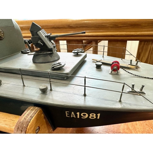 1440 - Model Torpedo Boat, Radio Controlled, with control unit and spare parts, and stand.  Measures 37'' l... 