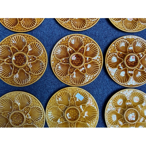 702 - Set of Twelve French Majolica Oyster Plates, in brown buff finish.