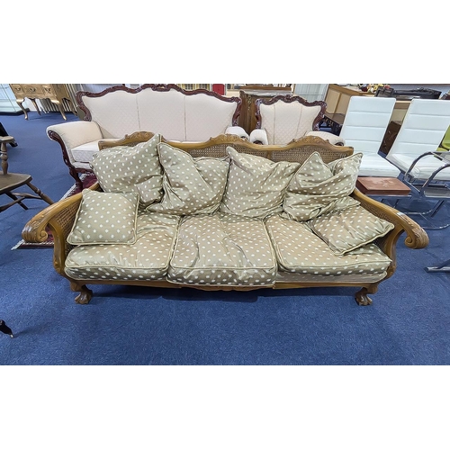 1051 - Bergere Settee, carved arm rests and back, raised on lion claw and ball feet.  Drop in cushions.  75... 