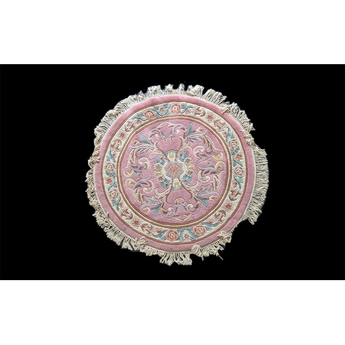 1076 - Pink Circular Rug, measures 4 feet diameter, pale pink with floral design and tassel trim.