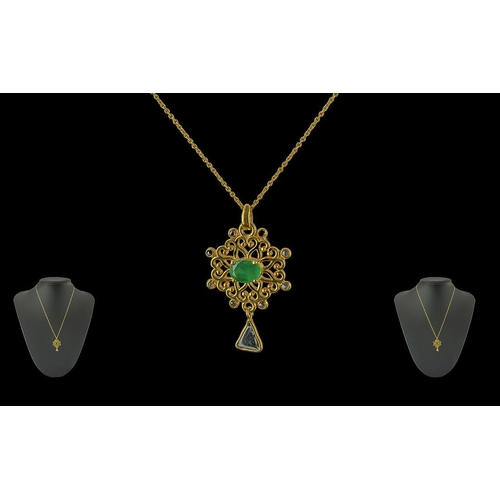 187 - Floral Pendant In Yellow Metal Set with oval emerald, round diamonds and a slice-cut diamond, boxed.... 