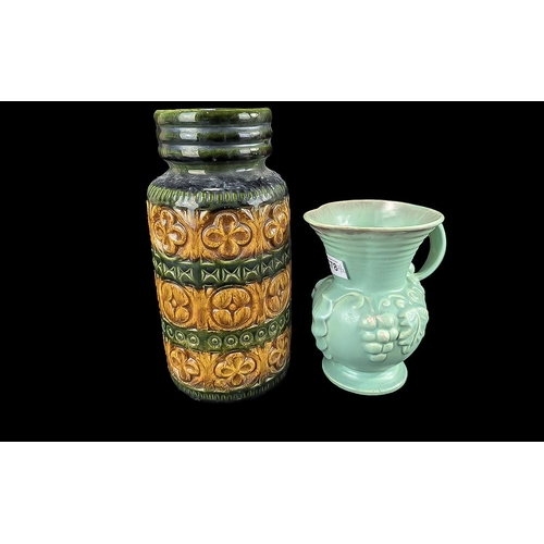 678 - Two West German Vases, comprising a green and amber coloured vase 11'', and a pale green jug decorat... 