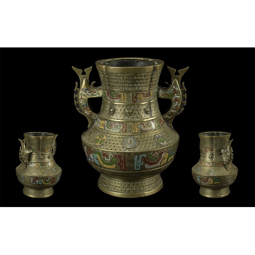 819 - An Antique Brass Cloisonne Vase, twin handled, in the archaic style, with enamel highlights.  Height... 