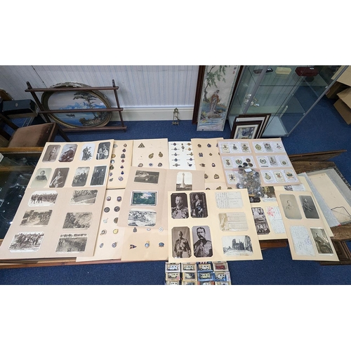 1302 - Collection of Militaria, comprising cloth badges, military photographs and postcards, together with ... 