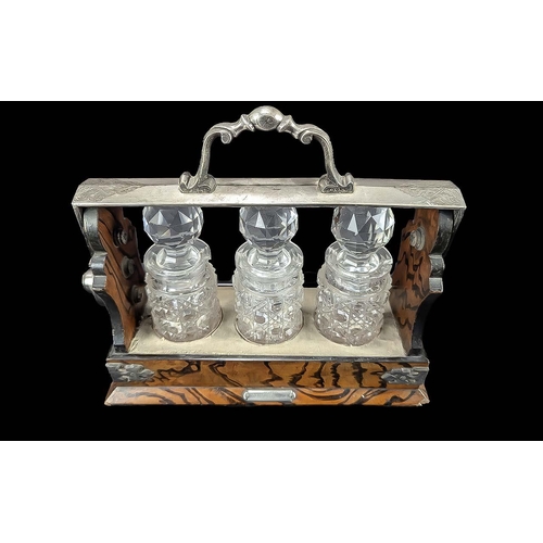 1030 - Mappin & Webb Miniature Tantalus, silver plated and oak frame, with three hobnail cut small decanter... 