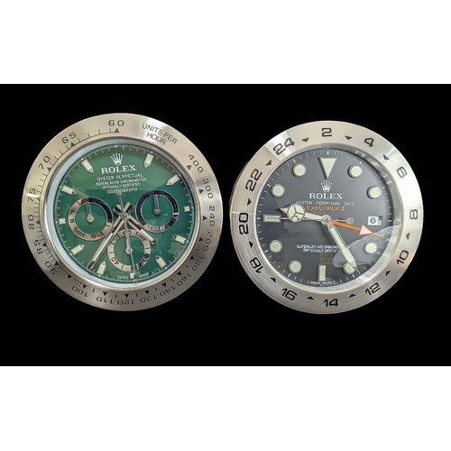 1107 - Two Rolex Style Dealer Display Wall Clocks, comprising one with a green face, date aperture, silver ... 