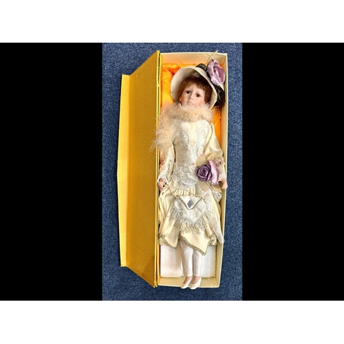 1501 - Large Modern China Faced Doll, dressed in a silk dess with hat and bag.  Approx 27'' tall, boxed.