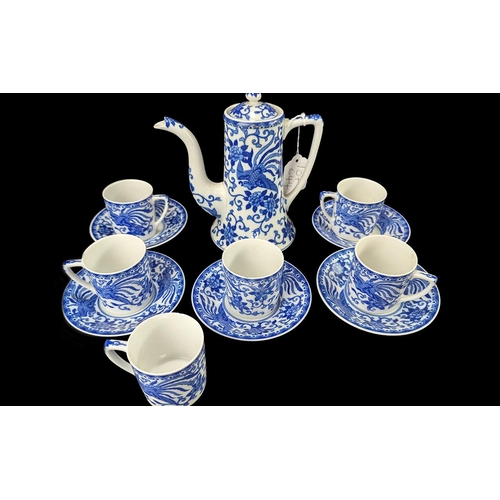 644 - Noritake Coffee Set, blue and white design, comprising coffee pot, six coffee cans and five saucers.