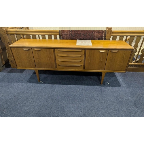 1045 - Younger Mid Century Sideboard, typical form, four central drawers between two storage cupboards, eac... 