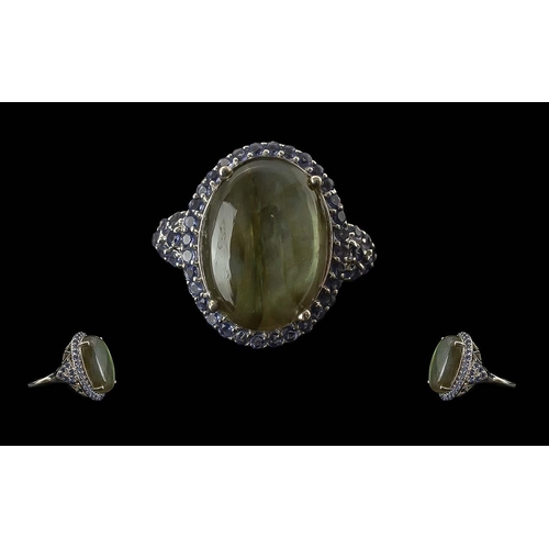 278 - Labradorite and Iolite Statement Ring, an 18ct oval cut cabochon of top quality labradorite, showing... 