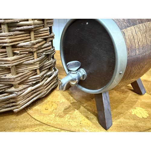 1498 - Flagon of Rum in Wicker Case, together with barrel shaped decanter and traveller's three compartment... 