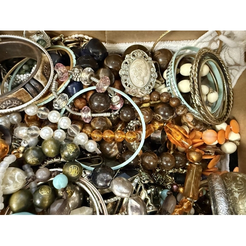 435 - Large Quantity of Costume Jewellery, contained in a banana box, comprising bangles, bracelets, beads... 