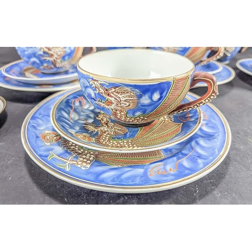 586 - A Blue Porcelain Japanese ''Dragonware'' Tea Service with Geisha girl to base of cups. Comprises two... 