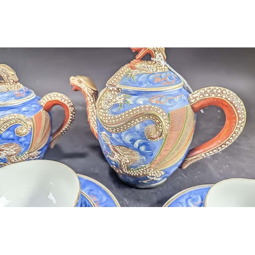 586 - A Blue Porcelain Japanese ''Dragonware'' Tea Service with Geisha girl to base of cups. Comprises two... 